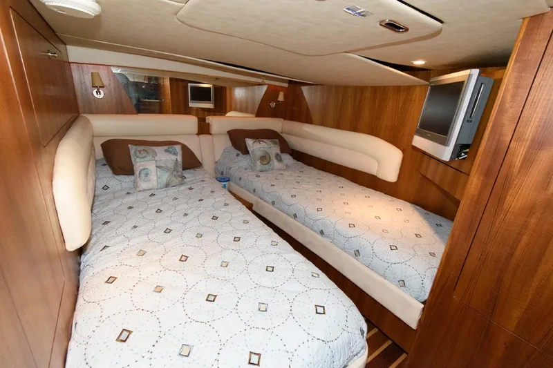 Slide: The Image of Luxurious 2006 Tiara Yachts 4300 Sovran cabin with twin beds and elegant wood paneling. - 21