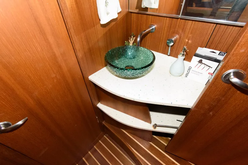 Slide: The Image of Luxurious 2006 Tiara Yachts 4300 Sovran bathroom with glass sink and wooden cabinetry. - 22