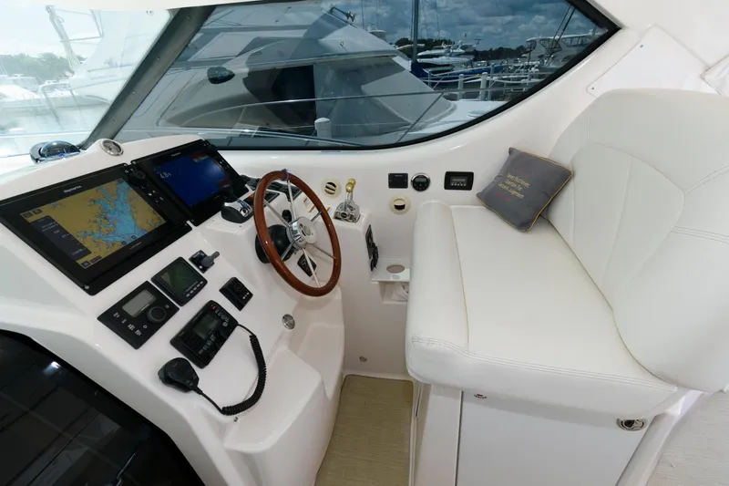 Slide: The Image of 2006 Tiara Yachts 4300 Sovran helm with navigation equipment and white seating. - 7