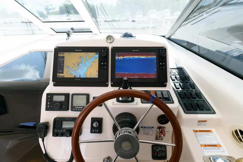 Slide: The Image of 2006 Tiara Yachts 4300 Sovran helm with navigation screens and steering wheel. - 9