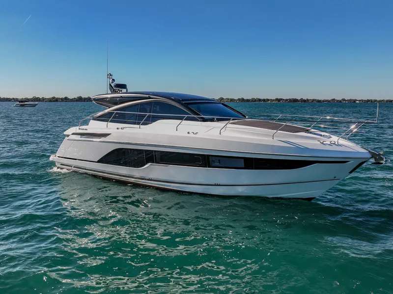 Slide: The Image of 2024 Fairline Targa 45 GT yacht cruising on open water under clear blue skies. - 2
