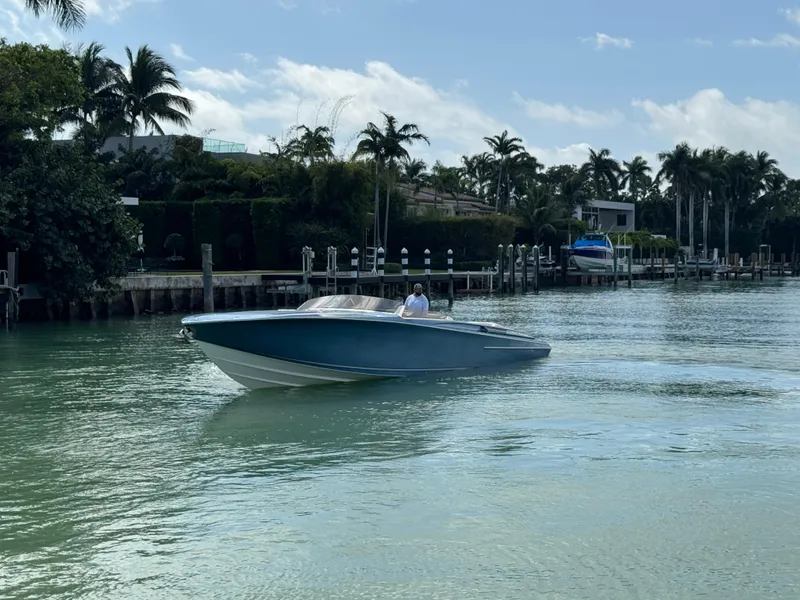 Slide: The Image of Nor-Tech 420 Monte Carlo 2013 cruising on a tropical waterway with palm trees. - 1