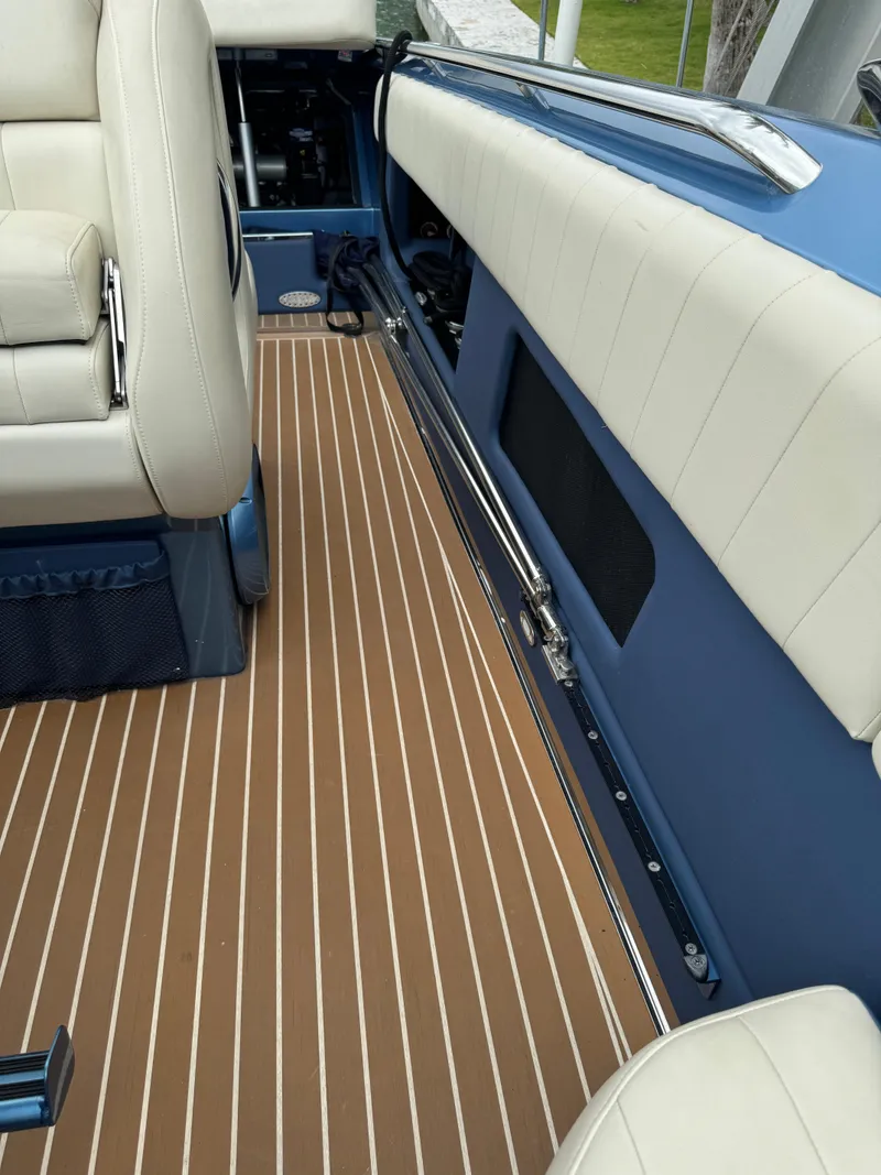Slide: The Image of 2013 Nor-Tech 420 Monte Carlo interior with beige seating and striped flooring. - 10
