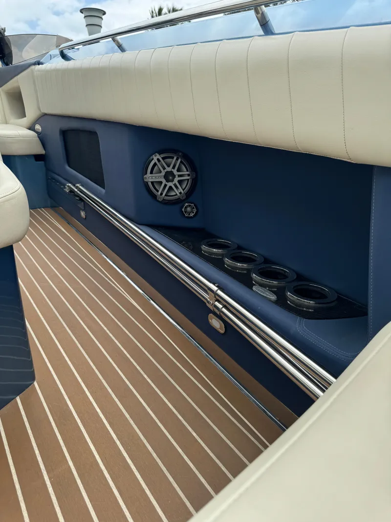 Slide: The Image of 2013 Nor-Tech 420 Monte Carlo interior with blue and white seating, speaker, and cup holders. - 11