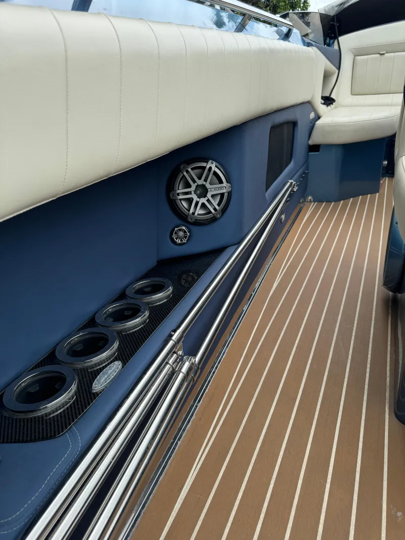 Slide: The Image of 2013 Nor-Tech 420 Monte Carlo interior with blue accents and striped flooring. - 12