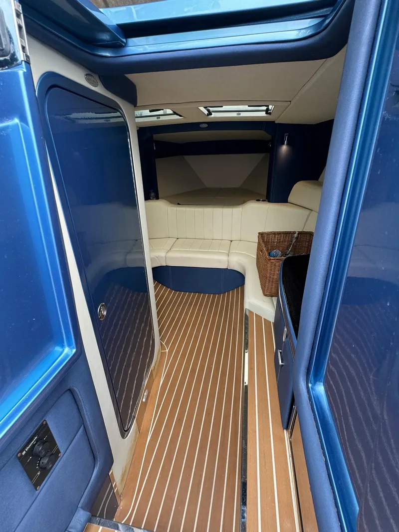 Slide: The Image of Interior of 2013 Nor-Tech 420 Monte Carlo with sleek blue and wood finish. - 14