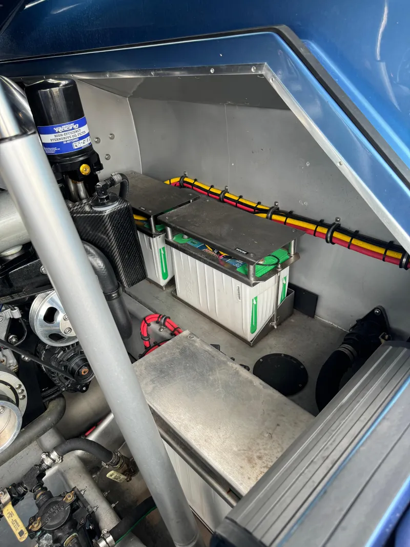 Slide: The Image of Engine compartment of 2013 Nor-Tech 420 Monte Carlo boat, featuring batteries and wiring. - 20