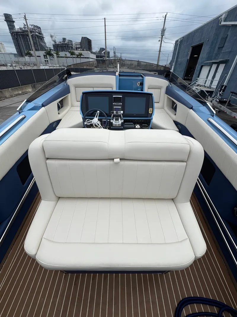 Slide: The Image of 2013 Nor-Tech 420 Monte Carlo boat interior with white seating and modern dashboard. - 25