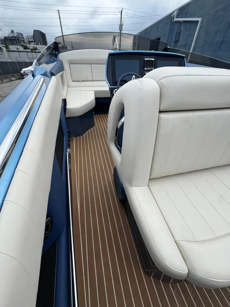 Slide: The Image of 2013 Nor-Tech 420 Monte Carlo boat interior with white seating and wood flooring. - 26