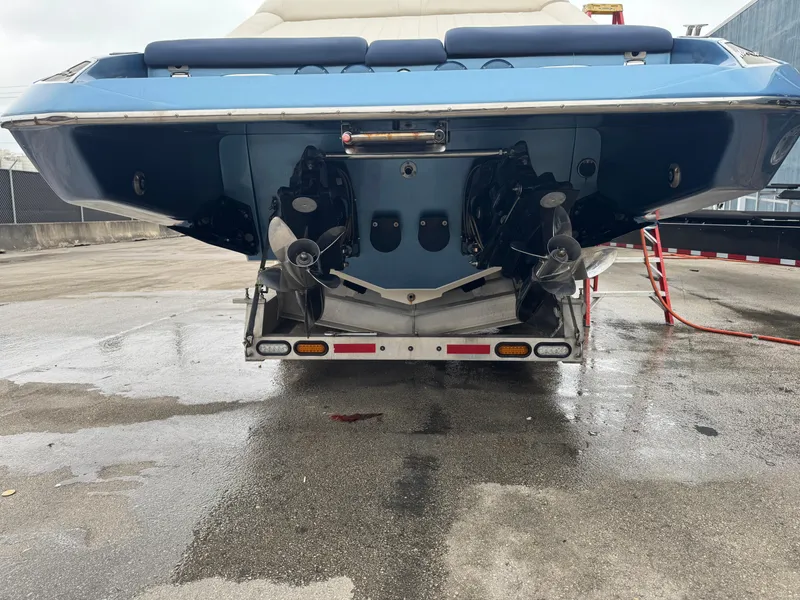 Slide: The Image of 2013 Nor-Tech 420 Monte Carlo boat rear view, showing dual propellers and wet pavement. - 28