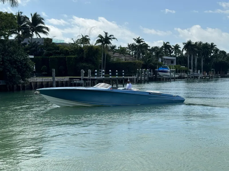 Slide: The Image of 2013 Nor-Tech 420 Monte Carlo cruising on a scenic waterway with palm trees. - 3