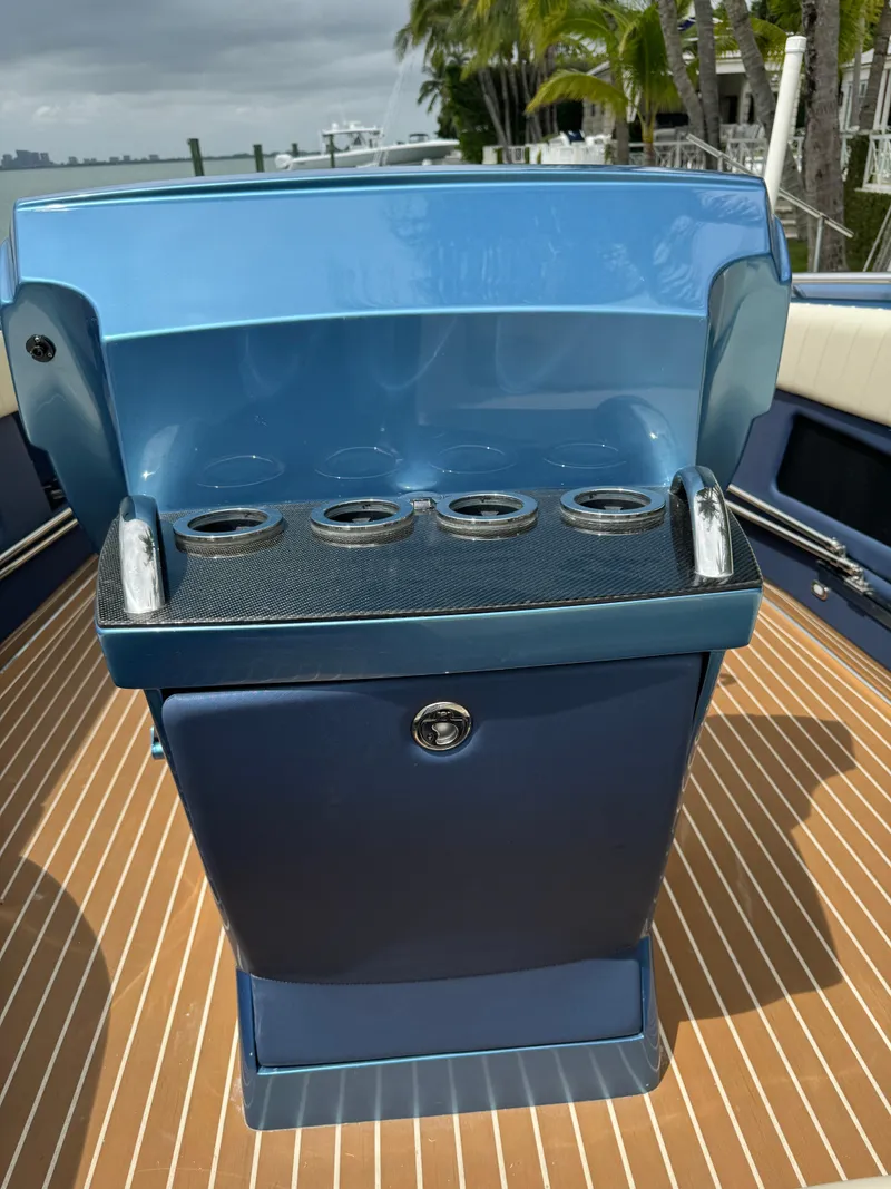 Slide: The Image of 2013 Nor-Tech 420 Monte Carlo boat console with cup holders, blue finish. - 8