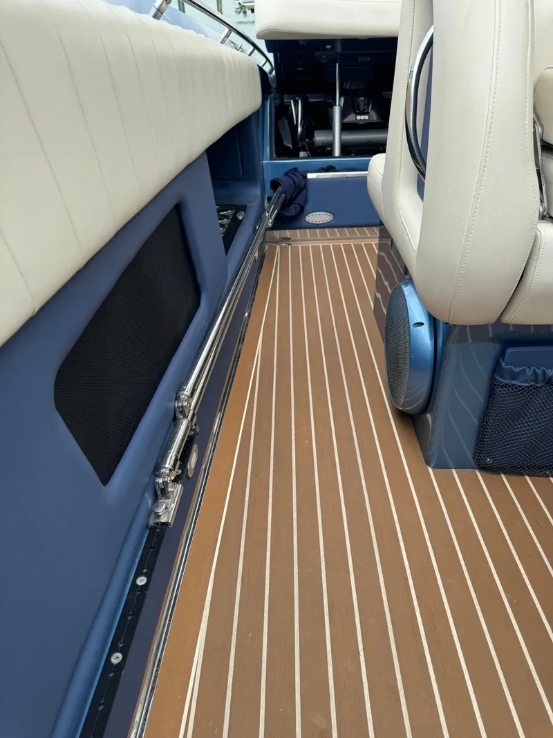 Slide: The Image of 2013 Nor-Tech 420 Monte Carlo interior with sleek seating and wood-patterned flooring. - 9