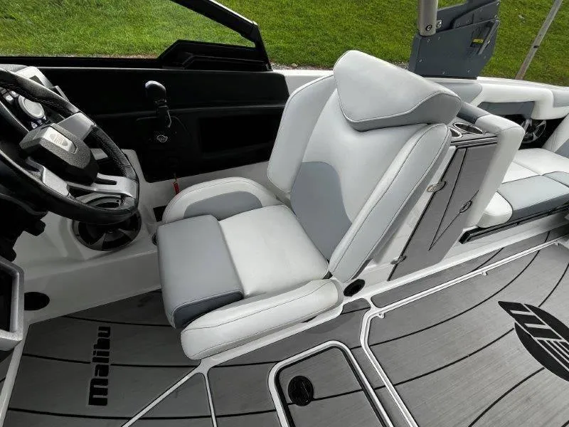 Slide: The Image of 2020 Malibu 25 LSV boat interior with sleek gray and white seating. - 30