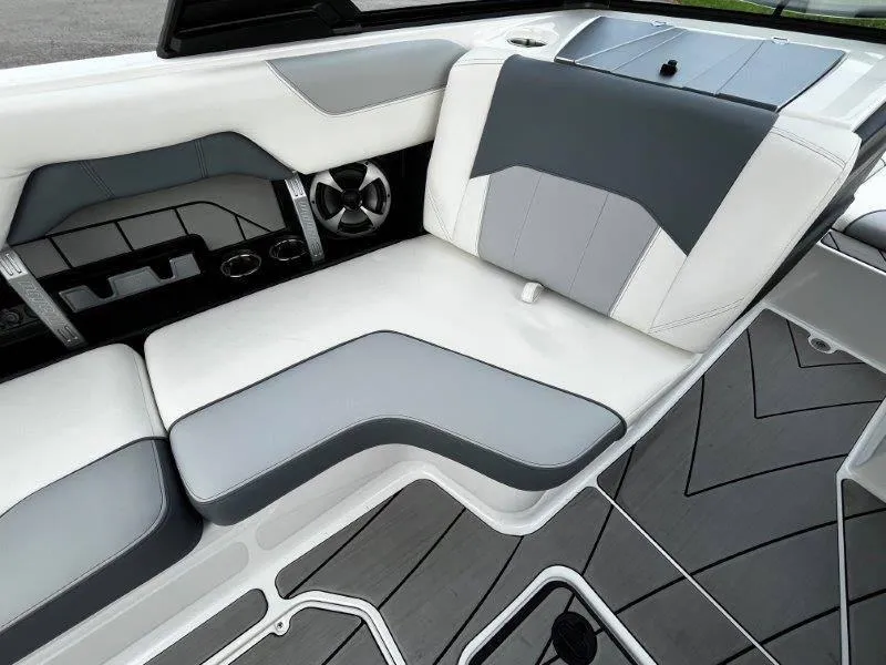 Slide: The Image of Interior seating of 2020 Malibu 25 LSV boat with gray and white upholstery. - 42