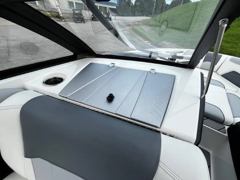 Slide: The Image of Interior of 2020 Malibu 25 LSV boat with sleek seating and windshield. - 49
