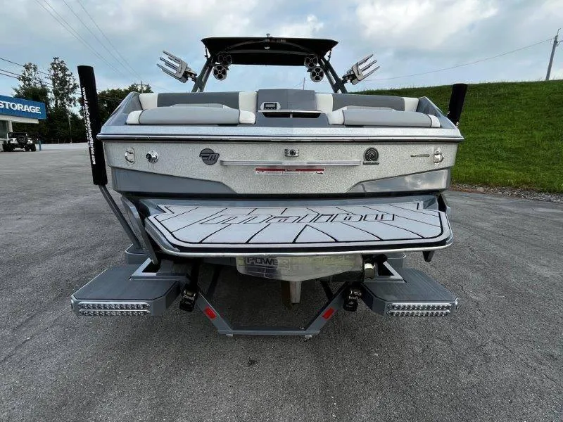 Slide: The Image of 2020 Malibu 25 LSV boat rear view with swim platform and speakers. - 6