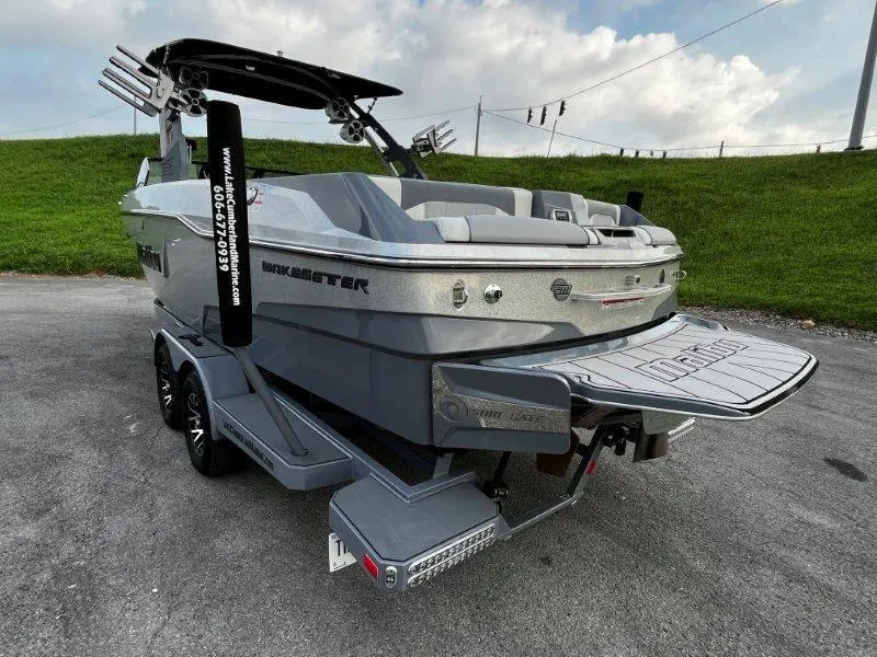 Slide: The Image of 2020 Malibu 25 LSV boat on trailer, rear view, parked on pavement. - 7