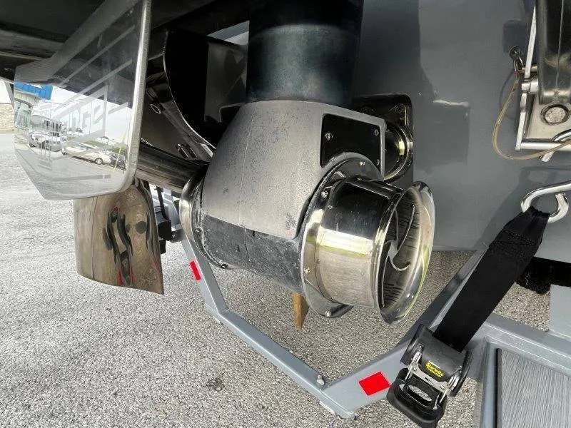 Slide: The Image of Close-up of 2020 Malibu 25 LSV boat propeller and rudder system. - 8