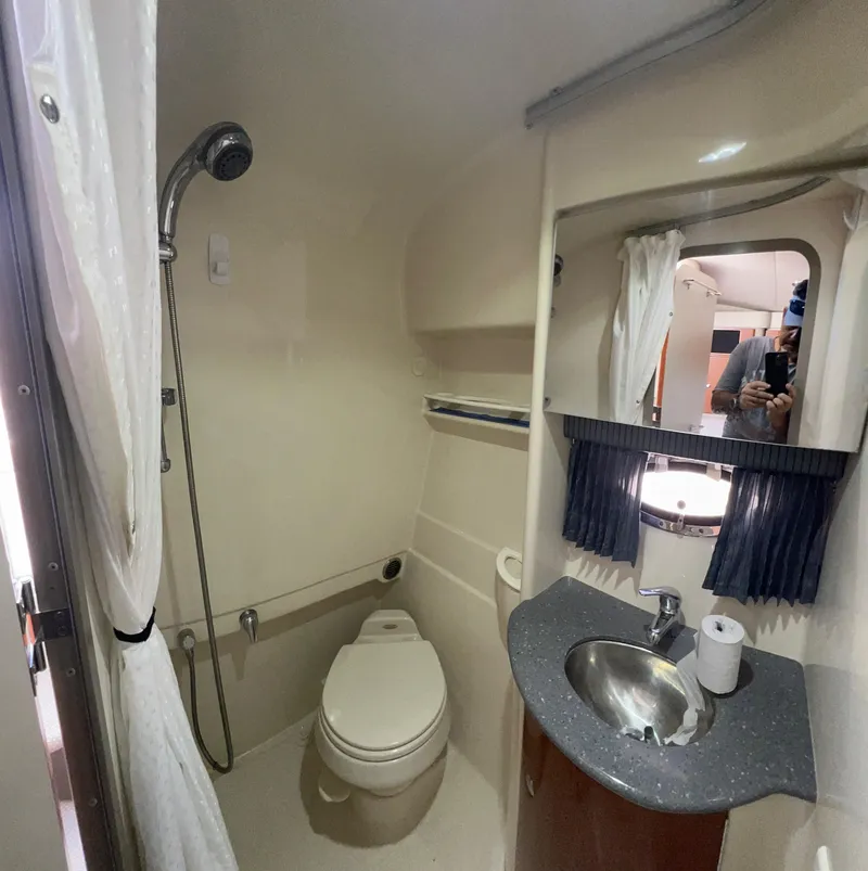 Slide: The Image of 2006 Formula 31 Cruiser bathroom with shower, toilet, sink, and mirror. - 10
