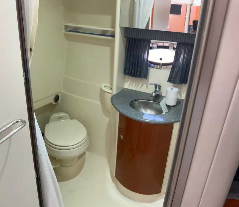 Slide: The Image of 2006 Formula 31 Cruiser bathroom with toilet, sink, and mirror. - 11