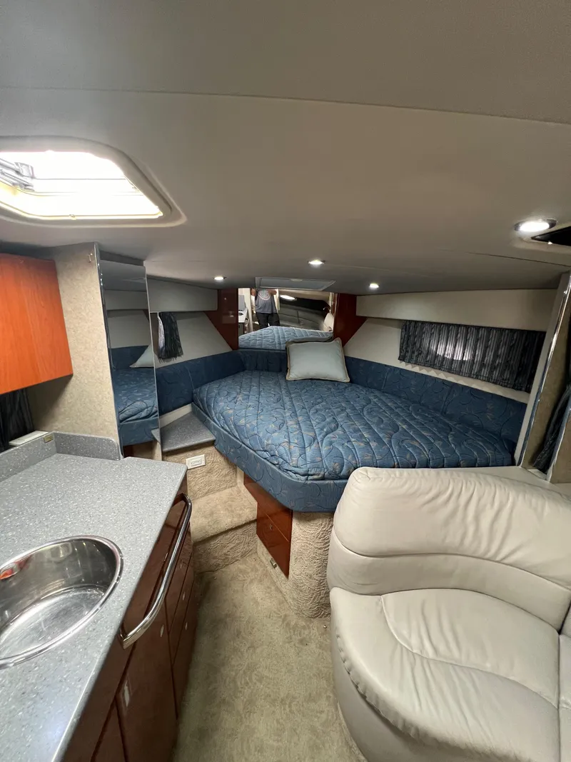 Slide: The Image of 2006 Formula 31 Cruiser interior with bed, kitchenette, and seating area. - 9