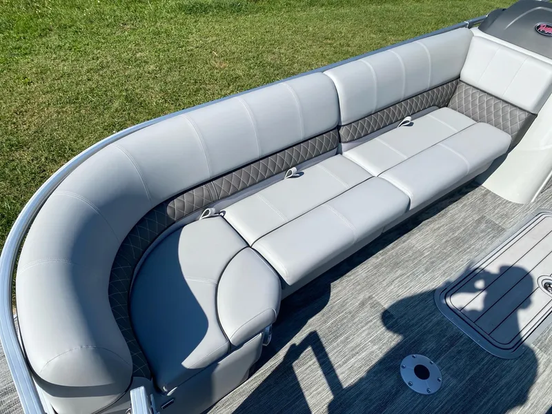 Slide: The Image of 2024 Ranger Reata 223C boat interior with plush seating and modern design. - 12