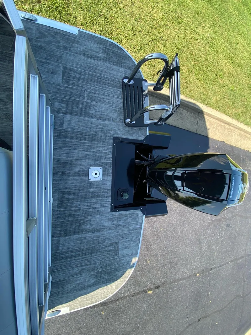 Slide: The Image of 2024 Ranger Reata 223C boat with motor, viewed from above on a sunny day. - 13