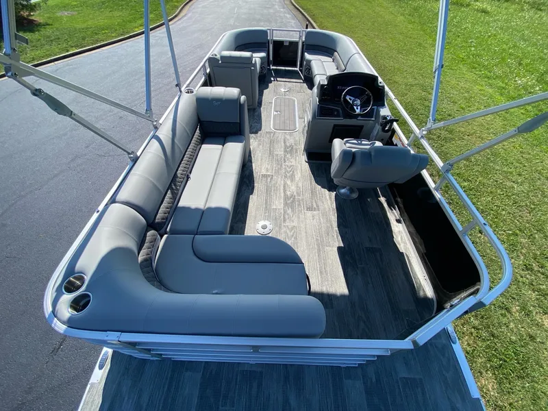 Slide: The Image of 2024 Ranger Reata 223C pontoon boat with spacious seating and modern helm. - 8