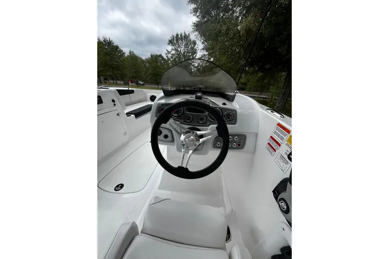 Slide: The Image of 2024 Tahoe 2150 boat cockpit with steering wheel and dashboard controls. - 5
