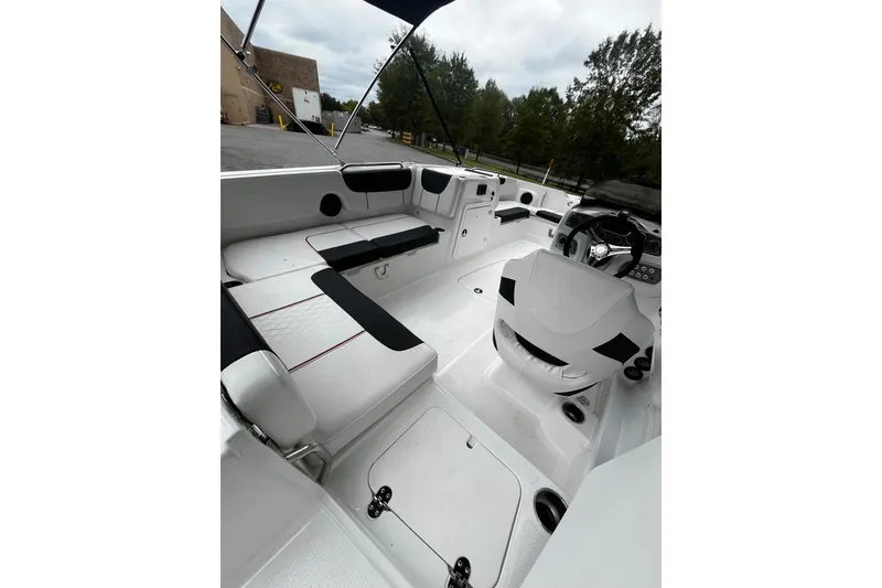 Slide: The Image of 2024 Tahoe 2150 boat interior with white seating and steering console. - 7