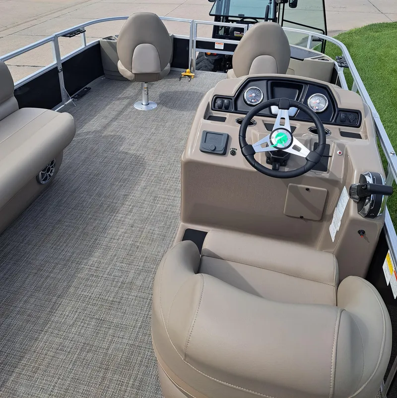 Slide: The Image of 2024 Ranger Reata 200F boat interior with steering console and seating. - 3