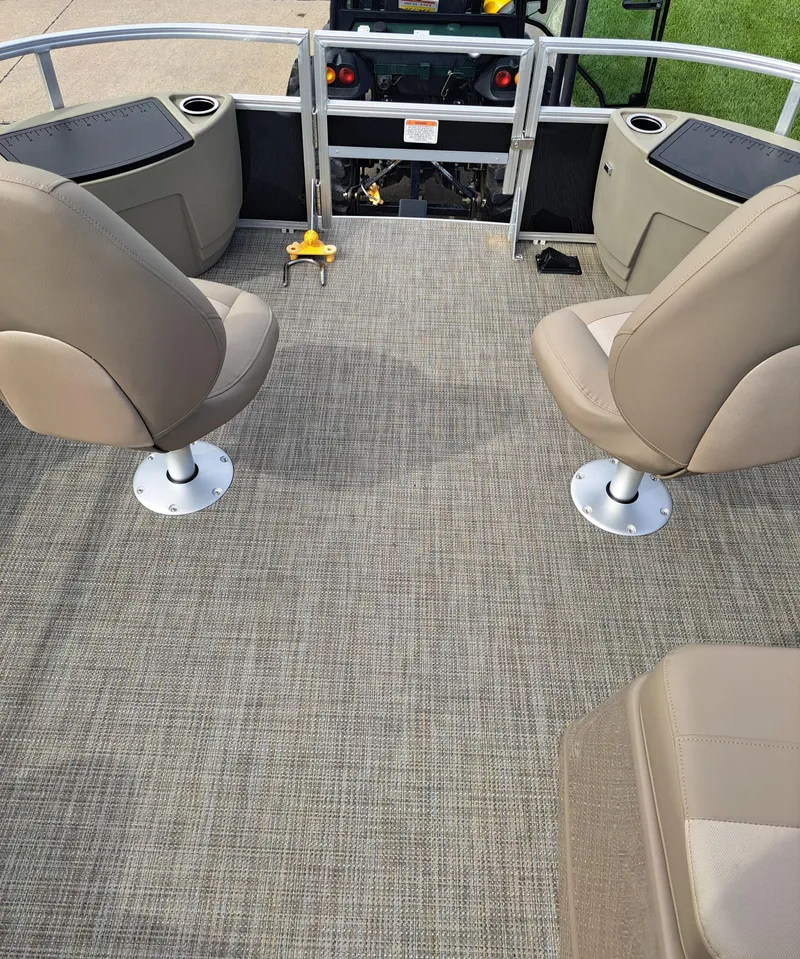 Slide: The Image of 2024 Ranger Reata 200F boat interior with beige seating and carpeted floor. - 4