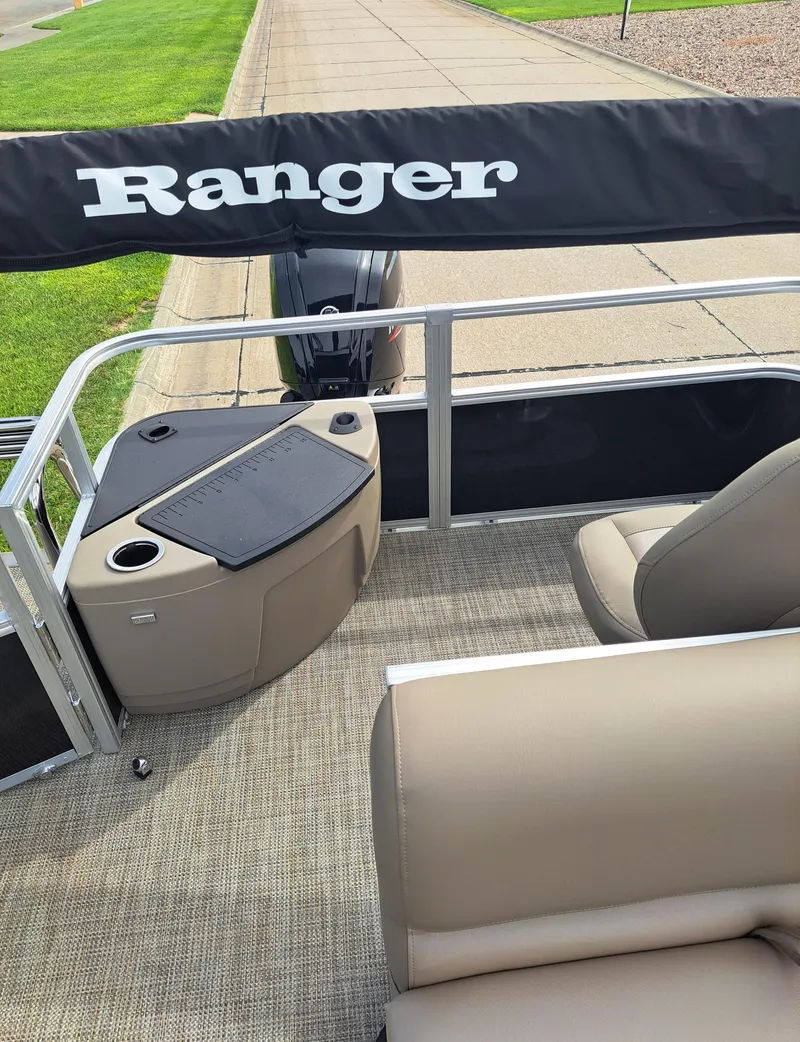 Slide: The Image of 2024 Ranger Reata 200F boat interior with seating and console. - 6