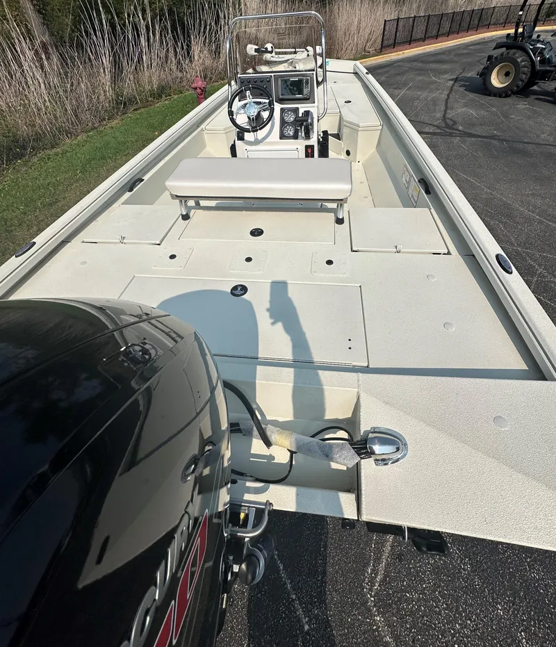 Slide: The Image of 2024 Ranger RB200 boat with outboard motor, parked on pavement. - 2