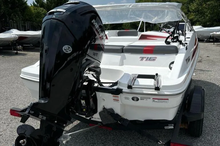 Slide: The Image of 2024 Tahoe T16 boat with Mercury outboard motor, parked on a trailer. - 2