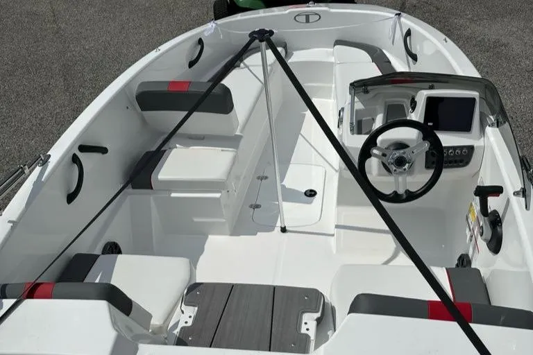 Slide: The Image of 2024 Tahoe T16 boat interior with steering wheel, seating, and control panel. - 4