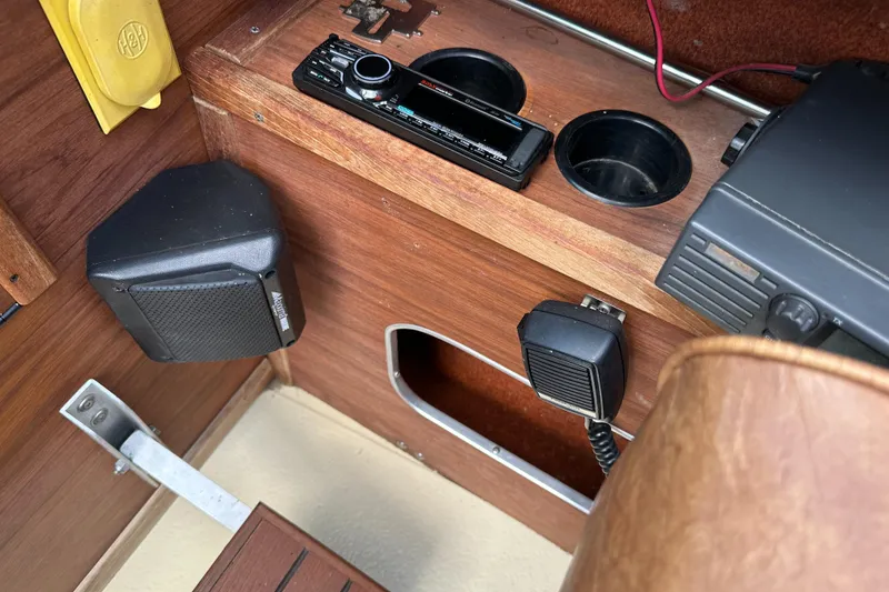 Slide: The Image of 1981 Sea Ray V240 boat interior with audio system and cup holders. - 12