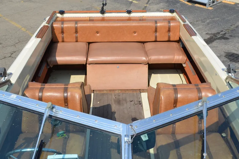 Slide: The Image of 1981 Sea Ray V240 boat interior with brown leather seating. - 4