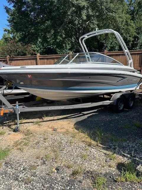 The Image of 2021 Crownline 220SS boat on trailer, parked outdoors. - 1
