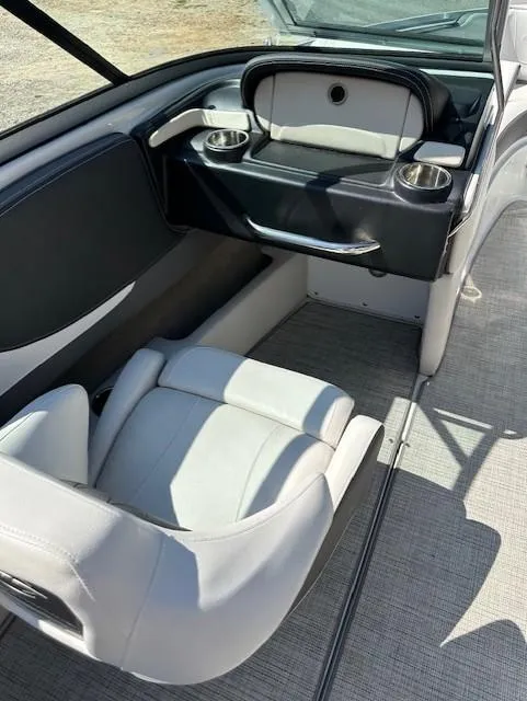 Slide: The Image of 2021 Crownline 220SS boat interior with seating and cup holders. - 10