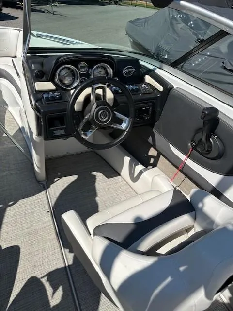 Slide: The Image of 2021 Crownline 220SS boat interior with modern dashboard and steering wheel. - 12