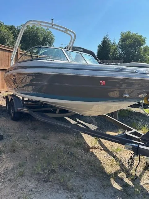 Slide: The Image of 2021 Crownline 220SS boat on trailer, parked outdoors. - 3