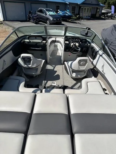 Slide: The Image of 2021 Crownline 220SS boat interior with seating and dashboard view. - 6