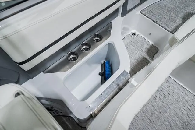 Slide: The Image of 2021 Cobalt R5 Surf boat interior storage compartment with brush. - 15
