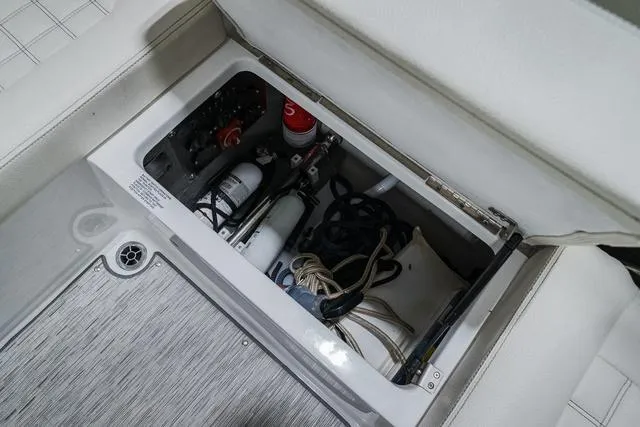 Slide: The Image of Storage compartment in 2021 Cobalt R5 Surf boat with safety equipment and ropes. - 16