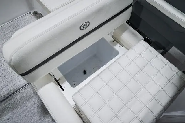 Slide: The Image of 2021 Cobalt R5 Surf boat interior with white cushioned seating and storage compartment. - 20