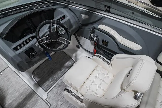 Slide: The Image of 2021 Cobalt R5 Surf boat interior with steering wheel and plush seating. - 21