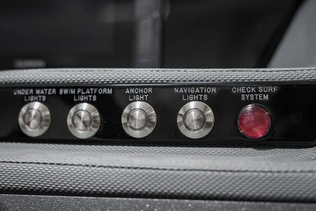 Slide: The Image of Control panel of 2021 Cobalt R5 Surf boat with light switches and surf system check. - 25