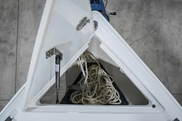 Slide: The Image of Open storage compartment on 2021 Cobalt R5 Surf boat with rope inside. - 30